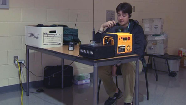 An amateur-radio operator testing equipment in a shelter after Superstorm Sandy.